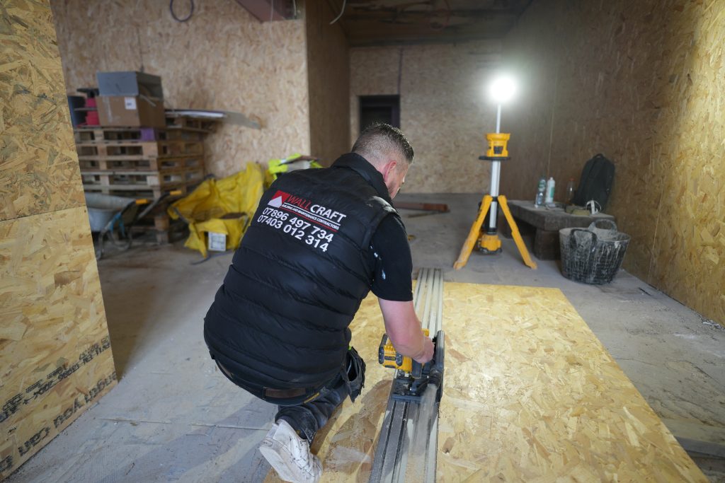 Wallcraft carpenter installing timber floor structure during a loft conversion project in Birmingham
